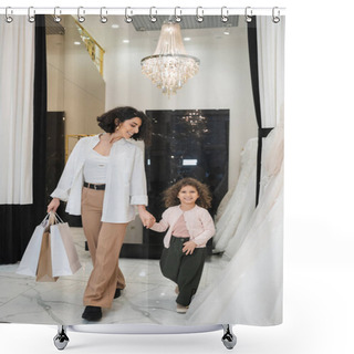 Personality  Happy Middle Eastern Woman With Brunette Hair In Beige Pants With White Shirt Holding Shopping Bags While Walking With Joyful Daughter Near Wedding Dresses In Bridal Salon, Modern Bride, Mother Shower Curtains
