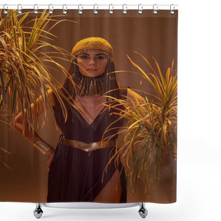 Personality  Woman In Egyptian Headdress And Necklace Posing Between Desert Plants Isolated On Brown Shower Curtains
