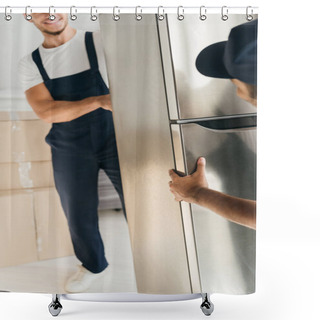 Personality  Fridge In Hands Of Smiling Multicultural Movers In Uniform On Blurred Background And Foreground  Shower Curtains