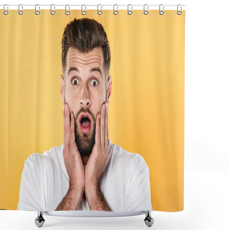 Personality  scared handsome man in white t-shirt with open mouth isolated on yellow shower curtains