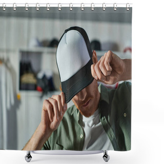 Personality  Young Craftsman Covering Face And Wearing Snapback While Standing And Working In Blurred Print Studio At Background, Customer-focused Entrepreneur Concept  Shower Curtains