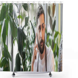 Personality  Bearded Barista In Apron Talking On Smartphone While Standing Near Plants In Coffee Shop, Banner Shower Curtains