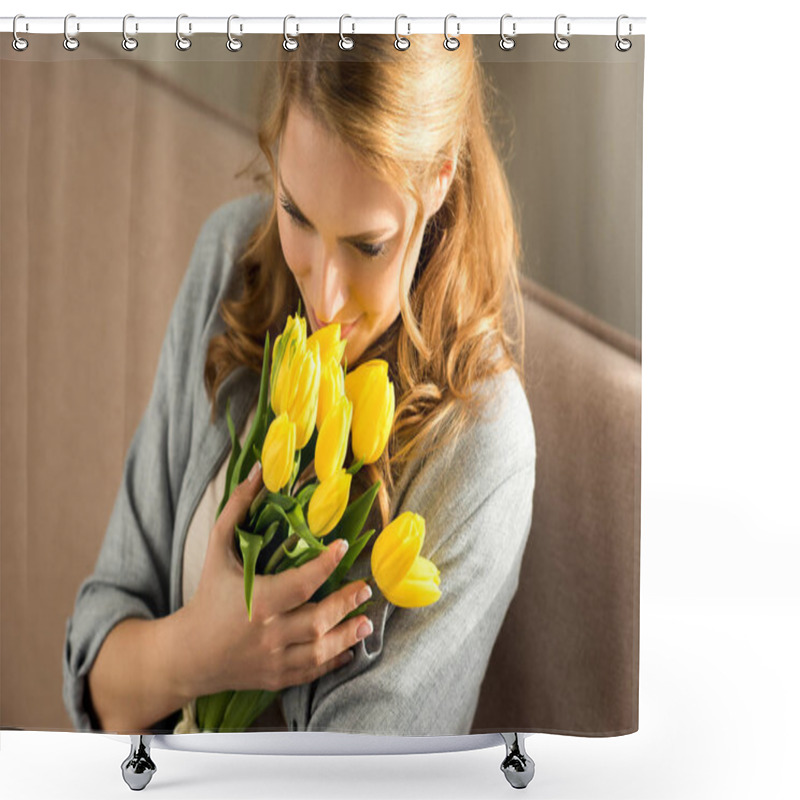 Personality  beautiful smiling young woman holding yellow tulips at home shower curtains