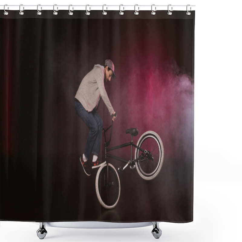 Personality  bmx cyclist performing stunt shower curtains