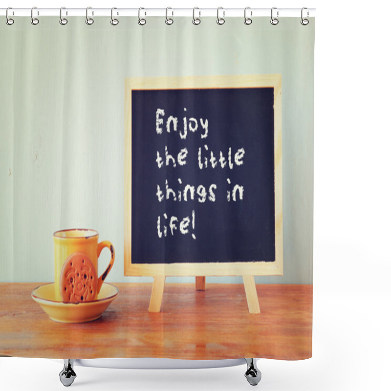 Personality  Blackboard with the phrase enjoy the little things in life next to coffee cup over wooden table shower curtains