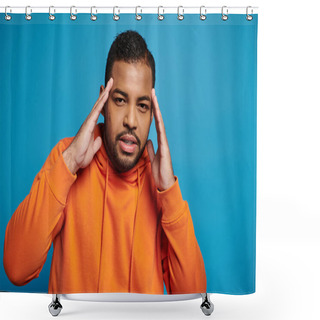 Personality  Thoughtful African American Man In Orange Outfit Touching To Temple With Hands On Blue Background Shower Curtains