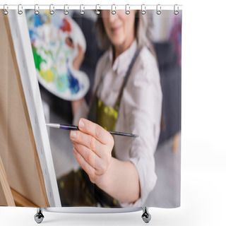Personality  Partial View Of Mature Woman Holding Paintbrush While Painting On Canvas With Blurred Foreground  Shower Curtains
