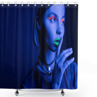 Personality  Portrait Of Woman In Neon Makeup Touching Green Lips While Showing Hush Sign On Dark Blue Background Shower Curtains