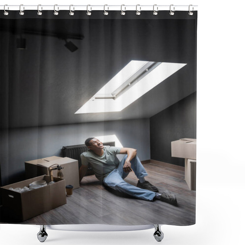 Personality  cheerful african american man sitting in sunlight near carton boxes on attic in new house shower curtains