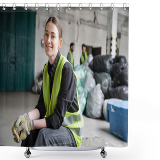 Personality  Cheerful Young Worker In Safety Vest And Gloves Looking At Camera While Resting And Sitting Near Blurred Plastic Bags In Garbage Sorting Center, Recycling Concept Shower Curtains