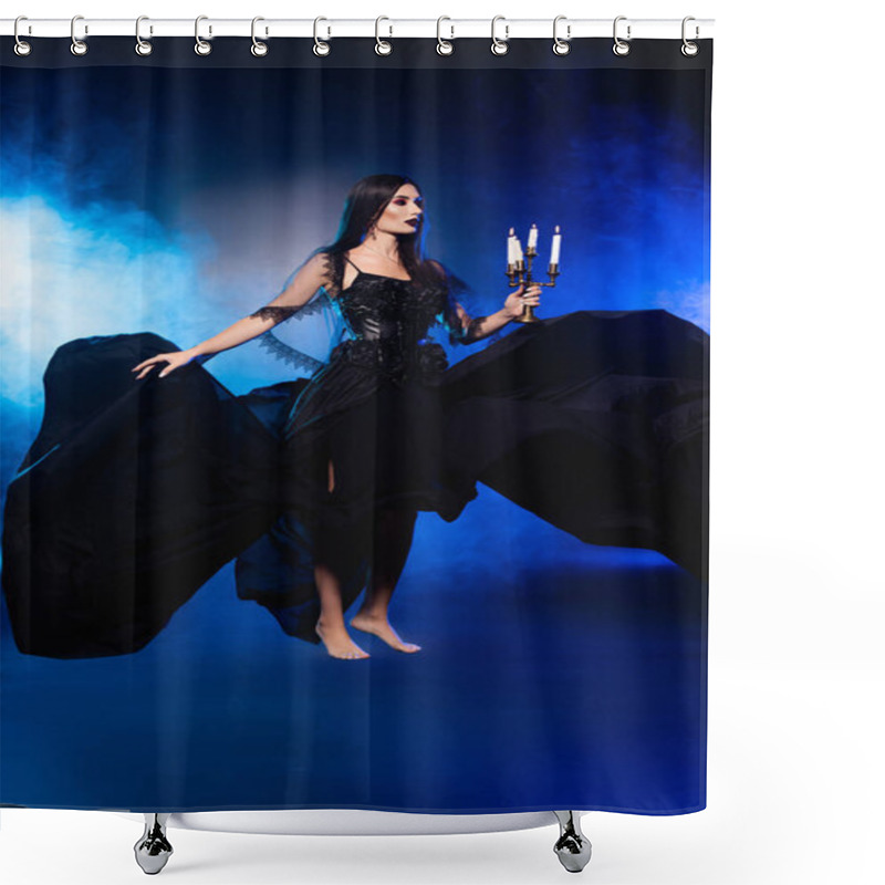 Personality  young pale woman in black dress holding candlestick with burning candles on blue with smoke shower curtains