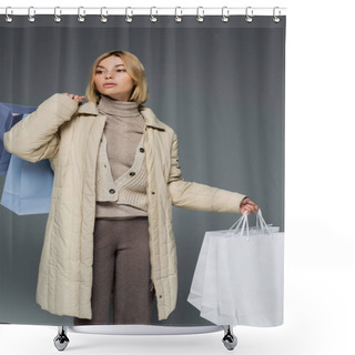 Personality  Blonde Young Woman In Warm Winter Coat Holding Shopping Bags Isolated On Grey  Shower Curtains