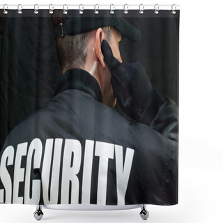 Personality  Security Guard Listens To Earpiece, Back Of Jacket Showing Shower Curtains