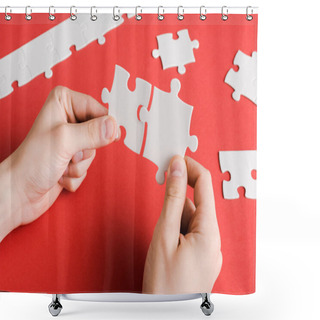 Personality  Cropped View Of Man Connecting White Puzzle Pieces In Hands On Red Shower Curtains