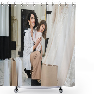 Personality  Happy Little Girl Hugging Cheerful Middle Eastern Bride With Brunette Hair In White Shirt Sitting Near Shopping Bags And Wedding Dresses In Bridal Salon, Mother And Daughter, Bonding  Shower Curtains