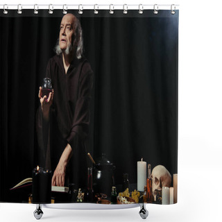 Personality  Thoughtful Alchemist Holding Jar With Liquid Near Magic Cookbook On Black Background  Shower Curtains