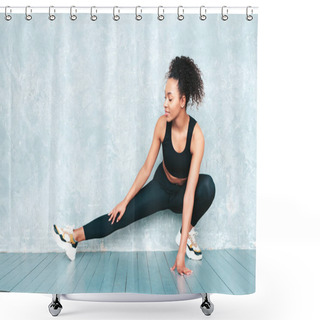 Personality  Portrait Of Fitness Smiling Black Woman In Sports Clothing With Afro Curls Hairstyle.She Wearing Sportswear.Young Beautiful Model Stretching Out Before Training.Female Sitting In Studio Near Gray Wall Shower Curtains