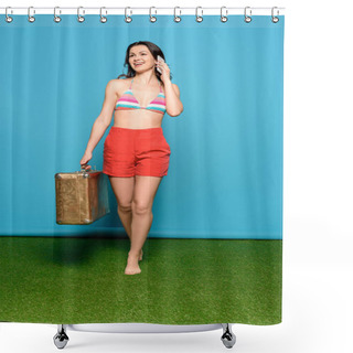 Personality  Happy Young Woman In Shorts And Swimsuit Bra Talking On Smartphone While Holding Vintage Suitcase On Blue Background Shower Curtains