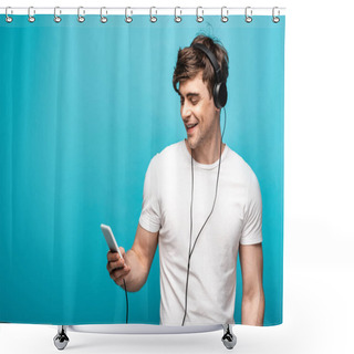Personality  Handsome Young Man Smiling While Listening Music With Headphones And Smartphone On Blue Background Shower Curtains