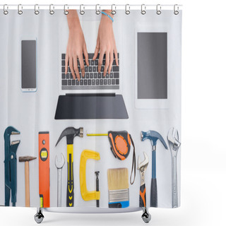 Personality  Cropped Shot Of Woman Using Laptop With Various Tools Lying On White Shower Curtains
