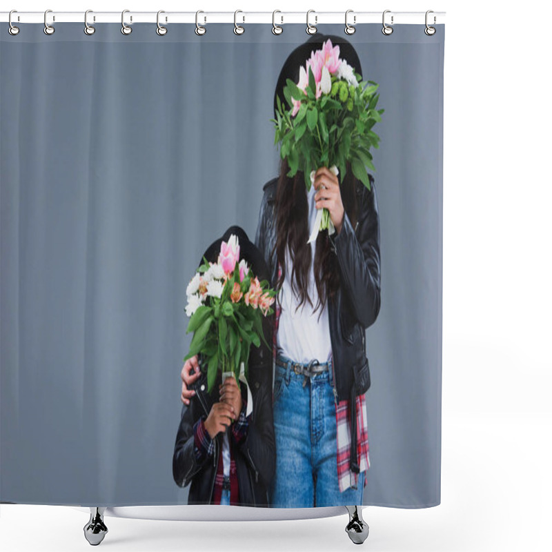Personality  mother and daughter covering faces with bouquets isolated on grey shower curtains
