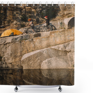 Personality  Distant View Of Two Male Travelers  Standing With Mountain Bikes Near Tent On Rocky Cliff Over River Shower Curtains