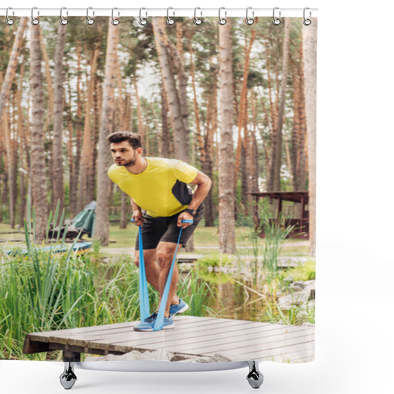 Personality  handsome man exercising with suspension straps near lake in forest  shower curtains