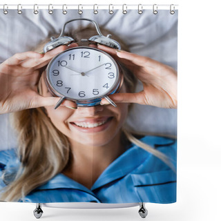 Personality  Top View Of Cheerful Woman Holding Retro Alarm Clock And Covering Face While Lying On Bed Shower Curtains