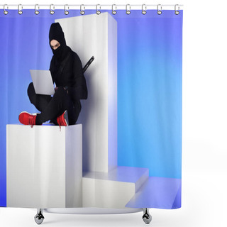 Personality  Ninja In Black Clothing Using Laptop While Sitting On White Block Isolated On Blue Shower Curtains