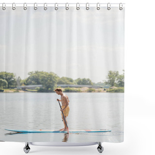 Personality  Side View Of Young And Redhead Man In Yellow Swim Shorts Sailing On Sup Board With Paddle On Lake With Green Shore During Water Recreation On Summer Weekend Shower Curtains