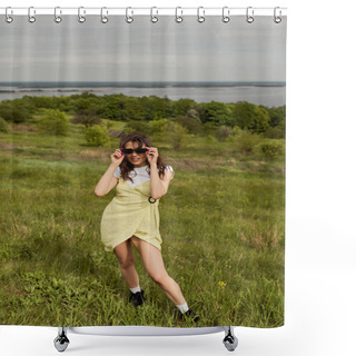 Personality  Cheerful Brunette Woman In Stylish Sundress Wearing Sunglasses While Standing And Spending Time On Grassy Meadow With Blurred Landscape And Cloudy Sky At Background, Summertime Joy Shower Curtains