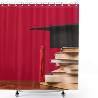 Personality  Cropped Image Of Academic Cap On Pile Of Books On Red Shower Curtains