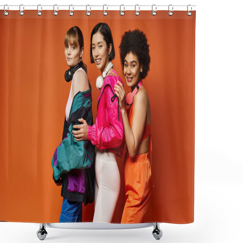 Personality  Three women of different ethnicities and styles standing together in a studio with a vibrant orange background. shower curtains