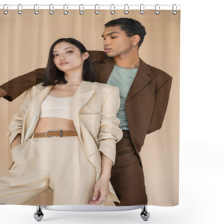 Personality  Sensual Asian Woman In Ivory Suit Posing With Hand In Pocket Near African American Man In Brown Blazer Isolated On Beige Shower Curtains