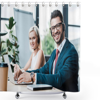 Personality  Selective Focus Of Cheerful  Man In Headset Typing On Laptop While Sitting Near Blonde Colleague  Shower Curtains