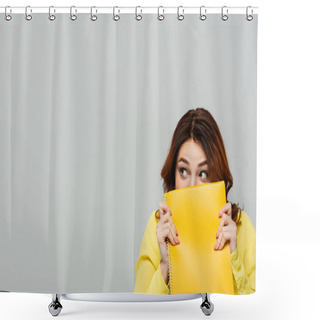 Personality  Scared Woman Looking Away While Obscuring Face With Notebook Isolated On Grey Shower Curtains