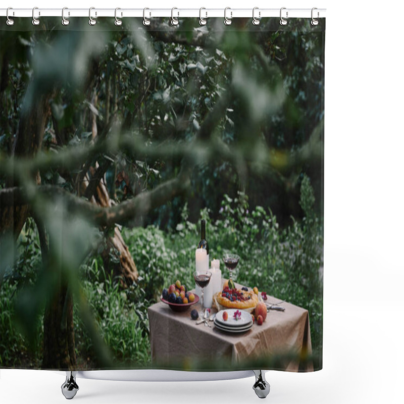 Personality  berries pie, wine and candles on table in garden with green trees shower curtains
