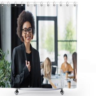 Personality  Cheerful African American Businesswoman Smiling At Camera Near Blurred Managers In Office Shower Curtains