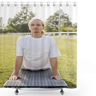 Personality  Young Positive Man In White T-shirt Looking At Camera While Practicing Cobra Pose On Yoga Mat Outdoors Shower Curtains