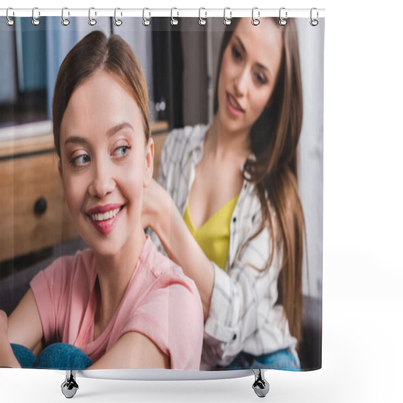 Personality  smiling woman hairdressing female friend by hair straightener on sofa at home shower curtains