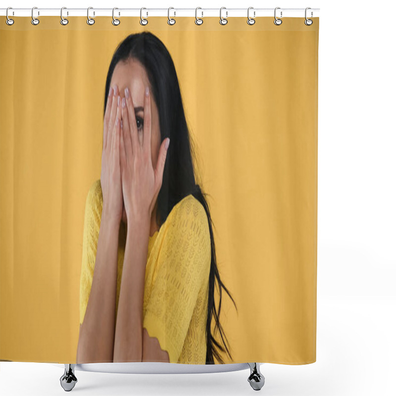 Personality  scared woman covering face with hands isolated on yellow shower curtains