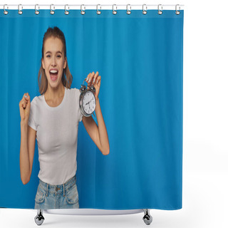 Personality  Excited Young Woman With Open Mouth Holding Alarm Clock On Blue Background, Face Expression Shower Curtains