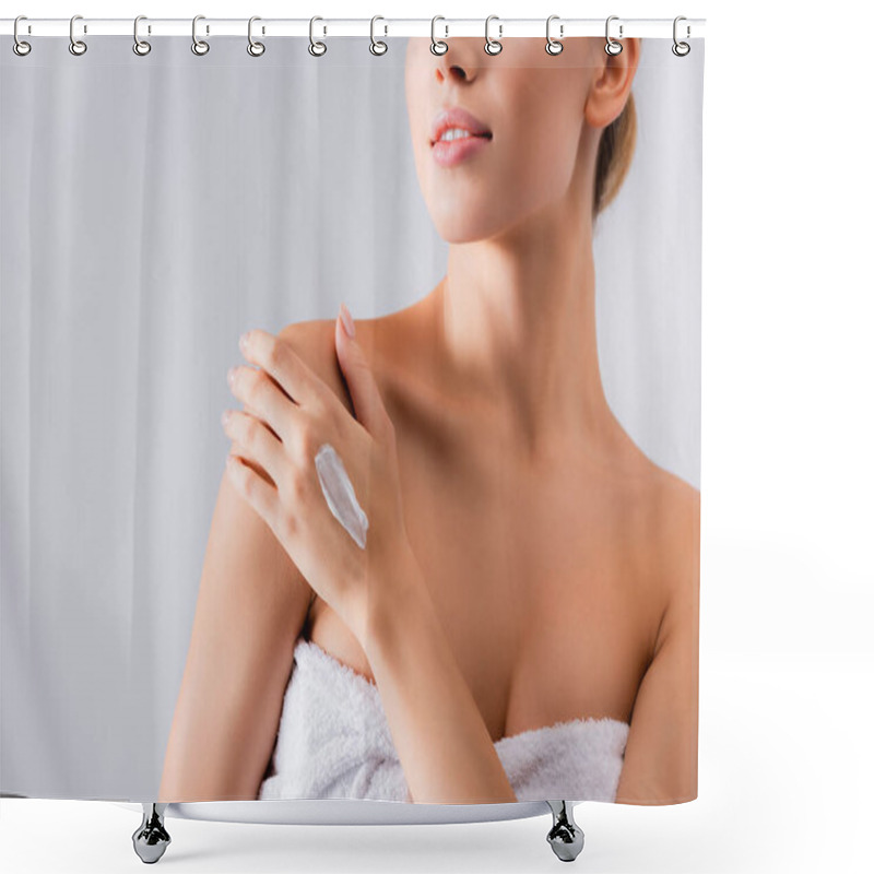 Personality  cropped view of young woman with bare shoulders and cream on hand on white shower curtains