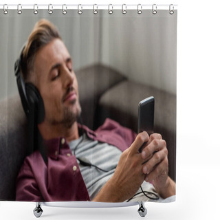 Personality  Happy Man With Smartphone And Closed Eyes Listening Music While Laying On Sofa  Shower Curtains