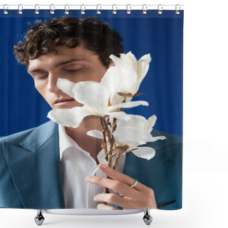 Personality  Portrait Of Curly Young Man In Jacket Holding Blurred Magnolia Branch Isolated On Blue  Shower Curtains
