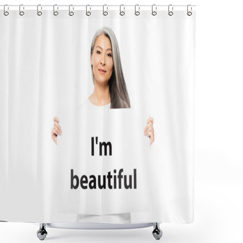 Personality  cheerful asian woman holding placard with i`m beautiful lettering isolated on white  shower curtains