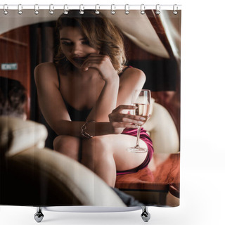 Personality  Selective Focus Of Seductive Girl Holding Champagne Glass While Sitting On Table Opposite Man In Plane Shower Curtains