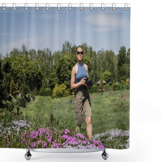 Personality  Young Short Haired Woman Tourist In Sunglasses Holding Digital Camera While Standing Near Blurred Flowers With Blurred Scenic Landscape At Background, Translation Of Tattoo: Love Shower Curtains