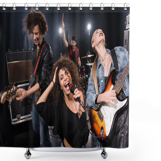 Personality  KYIV, UKRAINE - AUGUST 25, 2020:  Female Singer Of Rock Band With Microphone Singing Near Guitarists With Blurred Drummer On Background Shower Curtains