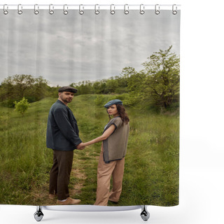 Personality  Fashionable Bearded Man In Jacket And Newsboy Cap Holding Hand Of Brunette Girlfriend And Looking At Camera With Landscape And Overcast At Background, Stylish Couple In Rural Setting Shower Curtains